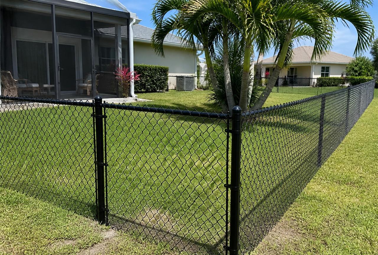 Black vinyl-coated chain link fence around a Florida backyard